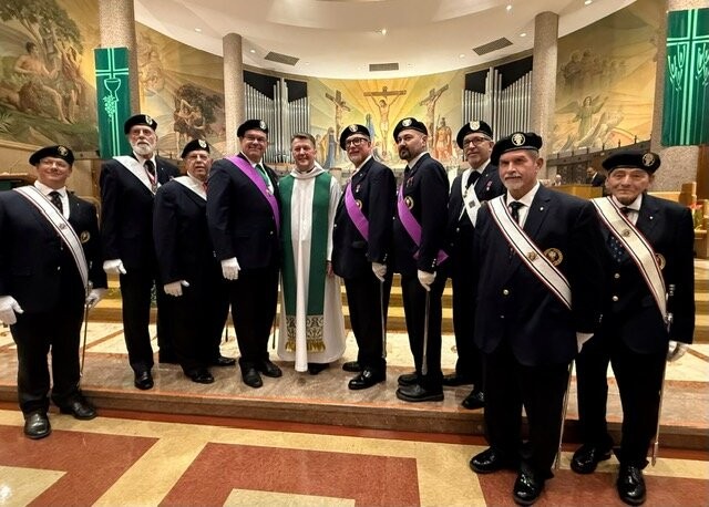 Sir Knights in Fourth Degree regalia with a priest in the sanctuary of St Clare of Montefalco
