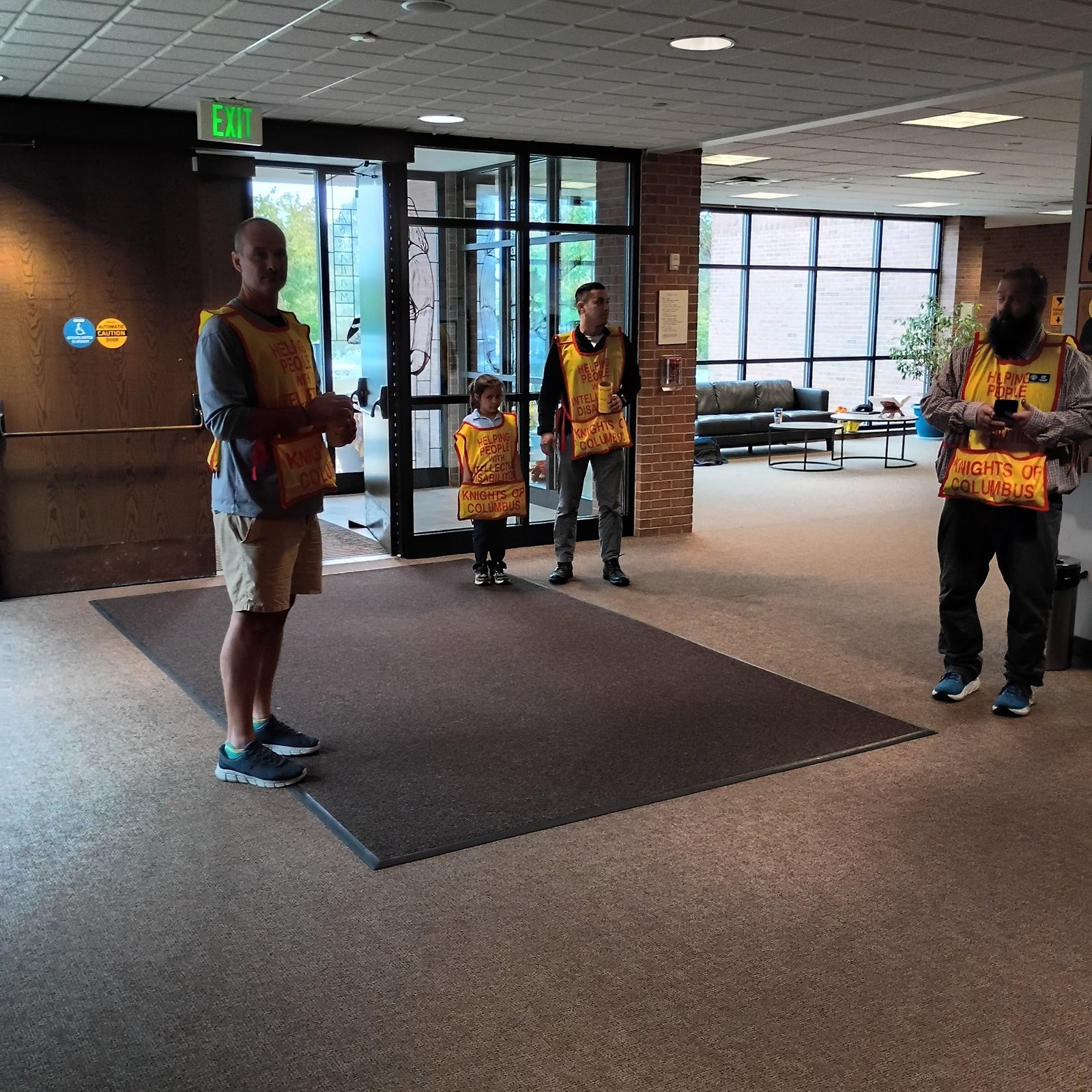 Council 6980 volunteers in MI Drive vests in the church lobby after Mass
